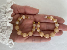 Load image into Gallery viewer, Add a touch of modern elegance to your look with these resin round beads chain C-Shape huggie earrings. Handmade with care, they feature glossy resin round beads paired with a sleek stainless steel chain for a lightweight yet durable finish. Inspired by trendy French fashion, these C-shape huggie earrings offer a stylish balance of chic and contemporary design, making them perfect for everyday wear or special occasions. A must-have statement accessory for women who love unique, fashionable jewelry.
