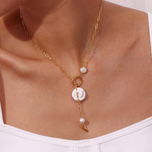 Load image into Gallery viewer, Introducing our elegant stainless steel gold necklace, a timeless piece that combines sophistication with modern design. Crafted from gold-tone stainless steel for durability and a lasting shine, this necklace features a chic toggle clasp adorned with two small natural freshwater pearls for a touch of refined elegance. At the bottom, a striking statement freshwater pearl adds a bold yet graceful focal point, making this necklace the perfect accessory for both special occasions and everyday luxury.
