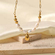 Load image into Gallery viewer, Stainless steel necklace is made as an interesting combination of chain and gold and white pearls. It is additionally adorned with a gold pendant in a shape of a teardrop.&nbsp; This beautiful and charming necklace is a great accessory for evening night out. The necklace has a lobster clasp and adjustable length.
