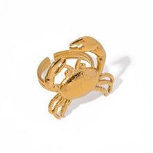 Load image into Gallery viewer, This stunning gold-colored stainless steel ring features a bold, eye-catching crab design that takes center stage, making it a striking statement piece. Perfect for adding a touch of coastal flair to your summer wardrobe, it also shines as a unique accessory for special occasions. The adjustable design ensures a comfortable fit, making it an ideal gift that’s both stylish and versatile. 
