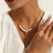 Load image into Gallery viewer, Stainless steel necklace is made as an interesting combination of chain and gold and white pearls. It is additionally adorned with a gold pendant in a shape of a teardrop.&nbsp; This beautiful and charming necklace is a great accessory for evening night out. The necklace has a lobster clasp and adjustable length.
