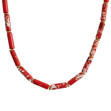 Load image into Gallery viewer, Necklace is made out of big red natural stone beads in a shape of a cilindar. There are small beads in between the red ones made of stainless steel in gold colour. This necklace is a perfect piece for summer elegant outfit. The necklace has a size adjustable chain with a lobster clasp.&nbsp;
