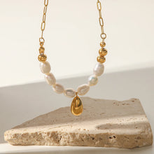 Load image into Gallery viewer, Stainless steel necklace is made as an interesting combination of chain and gold and white pearls. It is additionally adorned with a gold pendant in a shape of a teardrop.&nbsp; This beautiful and charming necklace is a great accessory for evening night out. The necklace has a lobster clasp and adjustable length.
