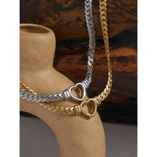 Load image into Gallery viewer, Stainless steel 18K gold plated necklace comes in a gold and silver colour. It is made of a thick and big chain which is adorned with a heart contour in the middle. This luxurious necklace is perfect accessory for any evening gown. It has lobster clasp and adjustable length.
