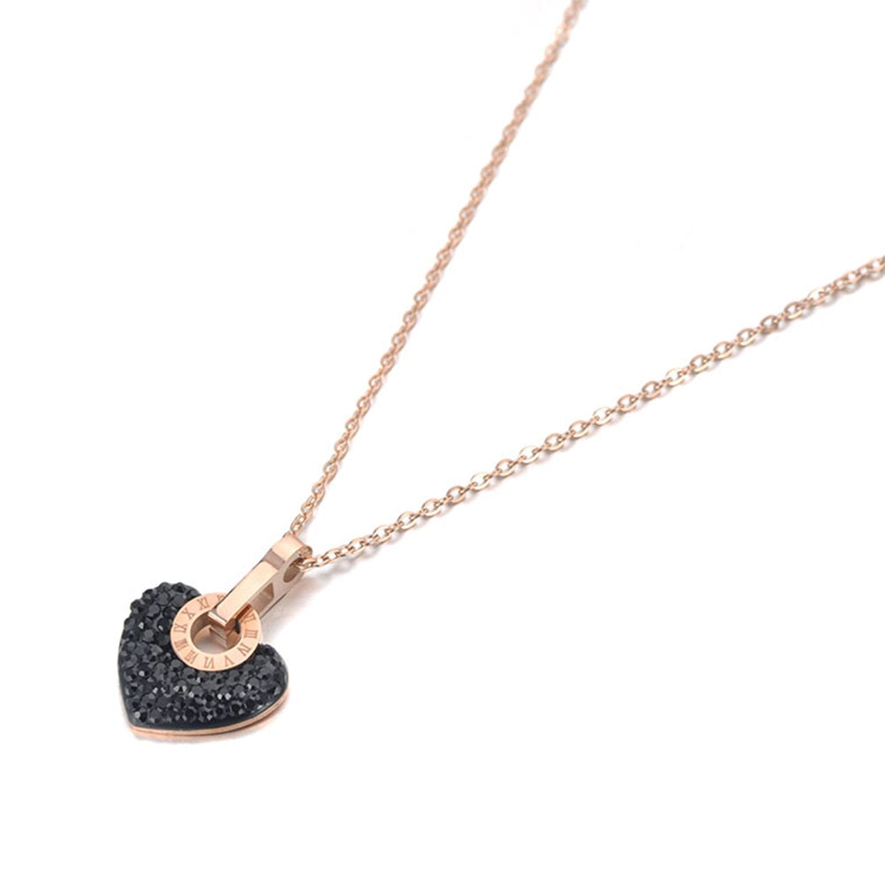 Beautiful and elegant 18K plated stainless steel necklace comes in two versions: with black or silver heart. Chic heart pendant is made of cubic zirconia and it is additionally adorned with a stainless steel circle in rose gold colour. Circe has engraved roman numerals and gives the necklace perfect final touch. It is a perfect piece for an elegant occasion outfit. The necklace has a size adjustable chain with a lobster clasp. 