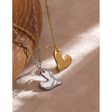 Load image into Gallery viewer, This simple stainless steel necklace comes in a gold and silver colour. It is adorned with a nice and delicate pendant in a shape of a heart. Irregular heart shape and its rugged surface gives this necklace a special touch. The necklace can be combined for any evening as well as for daily outfits. It has lobster clasp and adjustable chain.
