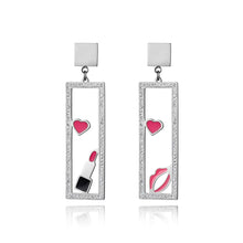 Load image into Gallery viewer, Add a playful touch to your look with these makeup elements pink lips &amp; lipstick earrings. Crafted from rose gold color stainless steel, these charming earrings feature a fun design of pink lips and a lipstick adorned with sparkling rhinestones. Perfect for beauty lovers, they combine durability with a touch of glamour, making them a unique accessory for any outfit or a thoughtful gift for someone special.
