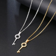 Load image into Gallery viewer, This simple and elegant necklace is made of stainless steel and real gold plating. It is adorned with a nice pendant in a shape of a key and comes in two colours: silver and gold. It can be perfect spice to an everyday outfit. It has lobster clasp. 
