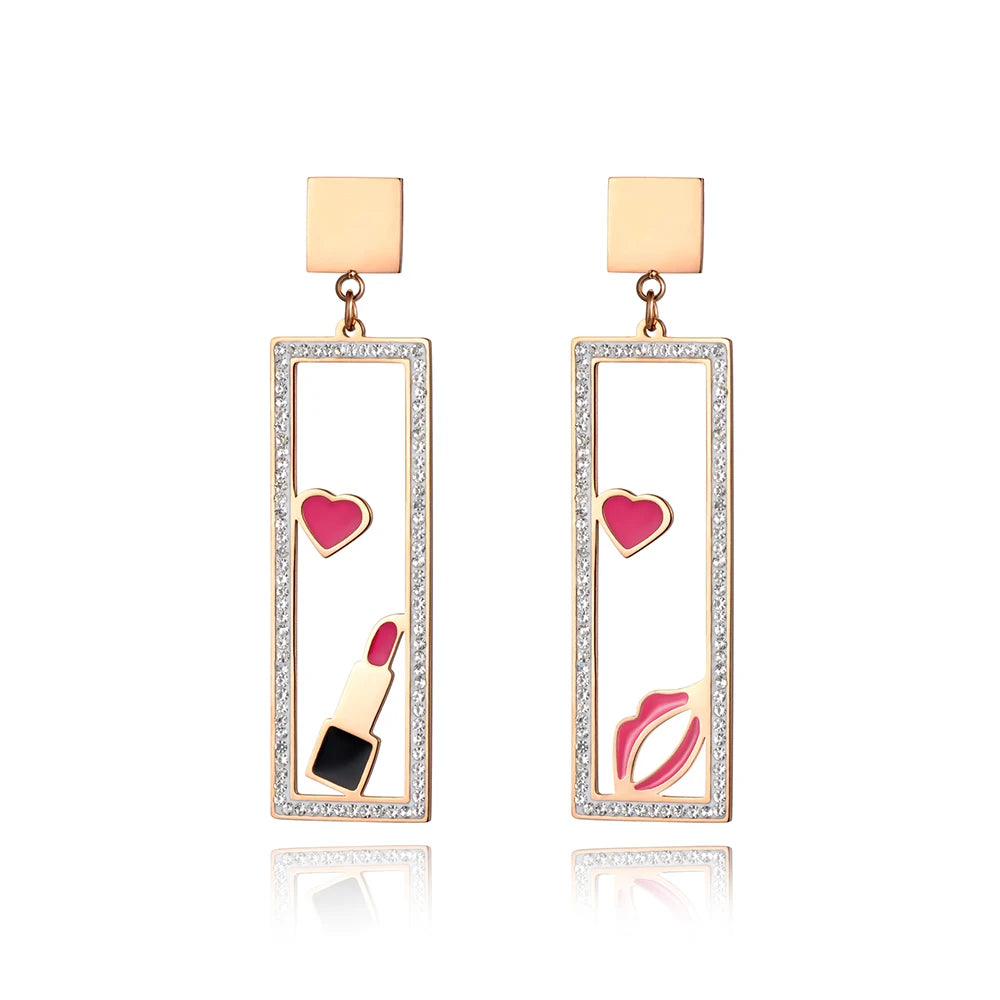 Add a playful touch to your look with these makeup elements pink lips & lipstick earrings. Crafted from rose gold color stainless steel, these charming earrings feature a fun design of pink lips and a lipstick adorned with sparkling rhinestones. Perfect for beauty lovers, they combine durability with a touch of glamour, making them a unique accessory for any outfit or a thoughtful gift for someone special.