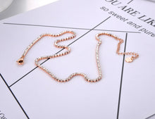 Load image into Gallery viewer, This beautiful tennis necklace is made of stainless steel and comes in three colours: rose gold, gold and silver. It is adorned with cubic zirconia which gives the necklace divine sparkling effect. This necklace is a perfect piece for an elegant occasion outfit. It has a size adjustable chain with a lobster clasp.&nbsp;
