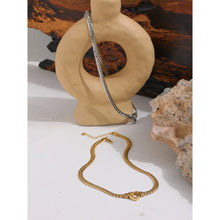 Load image into Gallery viewer, Stainless steel 18K gold plated necklace comes in a gold and silver colour. It is made of a thick and big chain which is adorned with a heart contour in the middle. This luxurious necklace is perfect accessory for any evening gown. It has lobster clasp and adjustable length.
