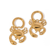 Load image into Gallery viewer, These stunning gold-colored stainless steel hoop earrings feature bold, eye-catching crab pendants that take center stage, making them a striking statement accessory. Perfect for adding a touch of coastal flair to your summer wardrobe, they also shine as unique pieces for special occasions. With their secure and comfortable design, these earrings are both stylish and versatile, making them an ideal gift.
