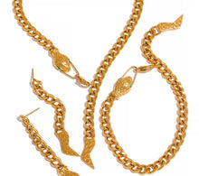 Load image into Gallery viewer, Stainless steel necklace comes in a gold colour. It is made of bigger link chain and it is adorned with a snake head on one side and snake tail on the other side of the necklace. Head is adorned with green cubic zirconia that represent eyes and it serves as a clasp. This luxurious necklace can be worn with any evening outfit and it will make it so glamorous. 
