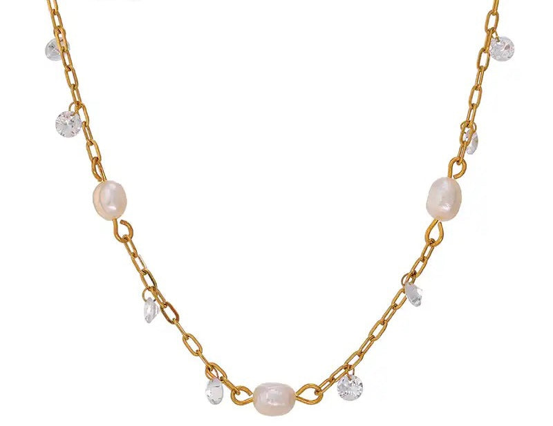 This romantic 18K gold plated stainless steel necklace comes in a gold colour. It is made as a combination of chain and natural freshwater pearls. The necklace is additionally adorned with little cubic zirconia that are attached to the chain. The necklace is perfect for spicing up your daily or evening outfit. It has lobster clasp and adjustable length.