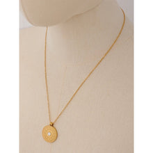 Load image into Gallery viewer, 18K gold plated stainless steel medallion necklace comes in gold colour. Statement medallion is adorned with a bigger cubic zirconia in the middle, and it represents lunar phases. It is a perfect piece for an elegant summer occasion outfit. The necklace has a size adjustable chain with a lobster clasp. 
