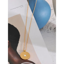 Load image into Gallery viewer, 18K gold plated stainless steel medallion necklace comes in gold colour. Statement medallion is adorned with a bigger cubic zirconia in the middle, and it represents lunar phases. It is a perfect piece for an elegant summer occasion outfit. The necklace has a size adjustable chain with a lobster clasp. 
