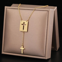 Load image into Gallery viewer, This elegant stainless steel necklace comes in two colours: silver and gold. Its very simple and elegant design is additionally adorned with two pendants: rectangle with a carved cross and a nice cross pendant which hangs from it on a separate chain. It is a perfect piece for an elegant occasion outfit. The necklace has a lobster clasp.&nbsp;
