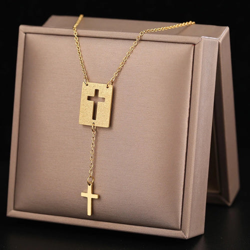 This elegant stainless steel necklace comes in two colours: silver and gold. Its very simple and elegant design is additionally adorned with two pendants: rectangle with a carved cross and a nice cross pendant which hangs from it on a separate chain. It is a perfect piece for an elegant occasion outfit. The necklace has a lobster clasp. 