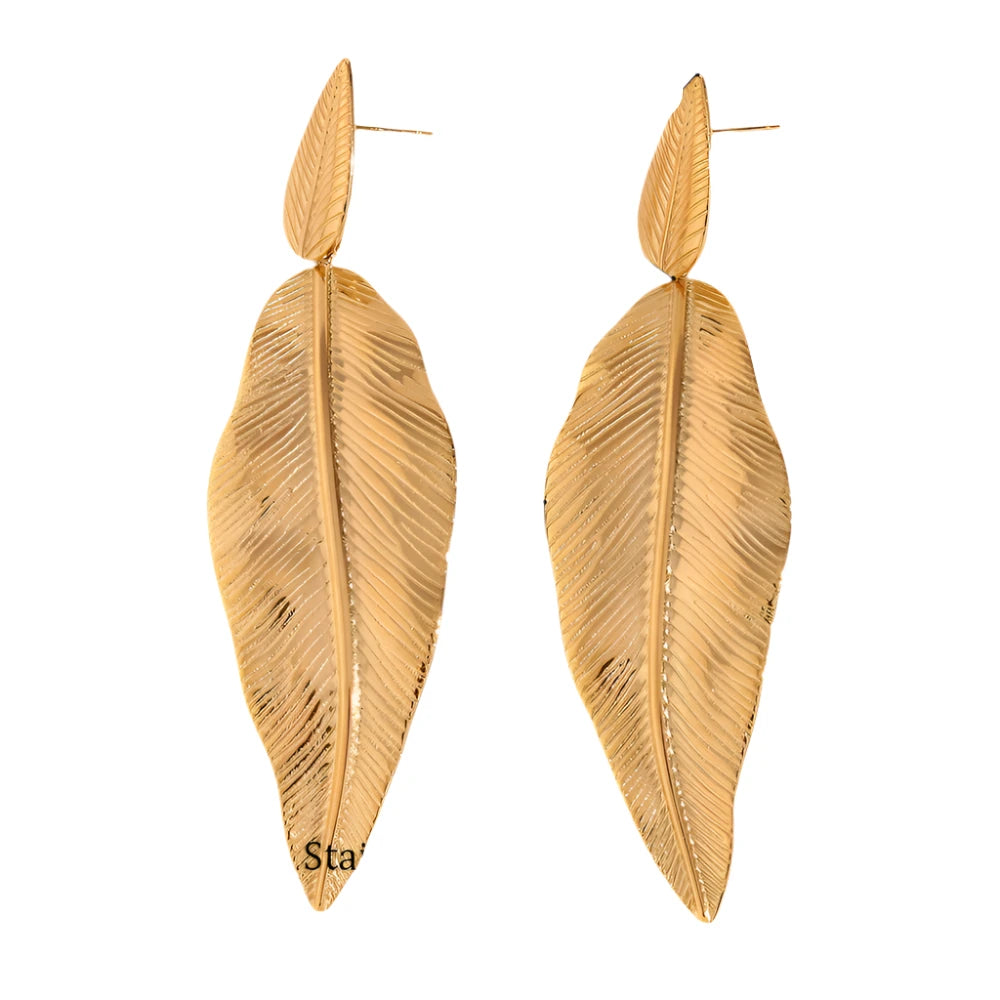 These striking dangle earrings feature a large, gold-plated stainless steel leaf hanging gracefully from a smaller, matching leaf, each adorned with intricate notches for added texture and dimension. The bold design makes these earrings a true statement piece, perfect for adding elegance to party outfits or enhancing everyday style with a touch of nature-inspired beauty.