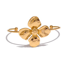 Load image into Gallery viewer, Embrace bold elegance with this stunning charm metal flower cuff bracelet, a statement piece designed to captivate. Featuring an intricate large flower motif, this open bangle is crafted from high-quality stainless steel and plated in radiant 18K gold for a luxurious finish. Its sleek, thin band beautifully contrasts with the striking floral design, creating a unique balance of sophistication and flair.
