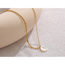 Load image into Gallery viewer, This chic pendant necklace is made out of 18K gold plated stainless steel. It has elegant bead chain and it is adorned with nice white shell moon pendant. Beads are smaller on one side and bigger on the other. The chain is additionally adorned with a small cubic zirconia pendant. This necklace is a perfect piece for an elegant occasion outfit. The necklace has a size adjustable chain with a lobster clasp.&nbsp;
