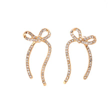 Load image into Gallery viewer, Add a touch of romance and sparkle to your look with these stunning zircon long bowknot dangle earrings. Designed to captivate, each earring features a delicate bow adorned with shimmering zircon stones, creating an elegant and eye-catching effect. Crafted from high-quality stainless steel, these earrings are available in both gold and silver, offering versatile options to match any outfit. 
