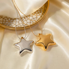 Load image into Gallery viewer, This statement stainless steel necklace comes in a gold and silver colour. It is adorned with a big bulging star pendant that is in contrast with a fine thin chain. This contrast makes it a perfect accessory for any rock glam outfit. The necklace has lobster clasp and adjustable chain.
