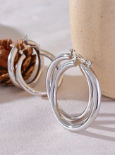 Load image into Gallery viewer, Elevate your style with these minimalistic big hollow hoop earrings, crafted from anti-allergic 316L stainless steel for lasting comfort and durability. Their sleek, round design offers a modern and trendy touch, perfect for adding effortless elegance to any outfit. Lightweight and versatile, these simple yet bold earrings are a must-have accessory for everyday wear or special occasions.
