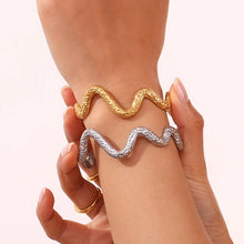 Load image into Gallery viewer, This striking open bangle bracelet features a unique hammered pattern and a sleek snake design, crafted from waterproof stainless steel for durability and style. Its bold, textured look adds an edgy yet elegant touch to any outfit, making it a perfect statement piece for fashion-forward women. 
