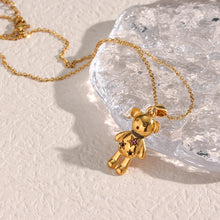 Load image into Gallery viewer, Necklace is made out of stainless steel and comes in two colours: gold and silver. Pendant is in a shape of a cute teddy bear and it is additionally adorned with cubic zirconia stars in pink colour. This beautiful necklace can be worn with daily or evening outfit. It has a size adjustable lobster clasp.
