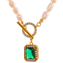 Load image into Gallery viewer, This romantic and luxurious necklace is made of natural freshwater pearls and stainless steel components. The necklace is adorned with a nice green stone circled with golden border and cubic zirconia.  There is a toggle clasp above the stone which is also adorned with cubic zirconia. Necklace is perfect accessory for any evening outfit. 
