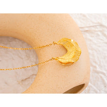 Load image into Gallery viewer, Statement stainless steel necklace comes in a gold colour. It is made of fine thin chain and it is adorned with a nice pendant in the shape of the crescent moon. Interesting shape of the pendant and its irregular surface makes this necklace very glamorous and interesting to be added to any outfit.. It has lobster clasp and adjustable length.
