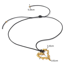 Load image into Gallery viewer, This glam rock necklace is made of gold plated stainless steel pendant which is hanging on a black wax rope. The hollow heart pendant comes in two colours: gold and silver. Its shape imitates lava, which gives the necklace an interesting look. It is a perfect piece for any daily occasion. 
