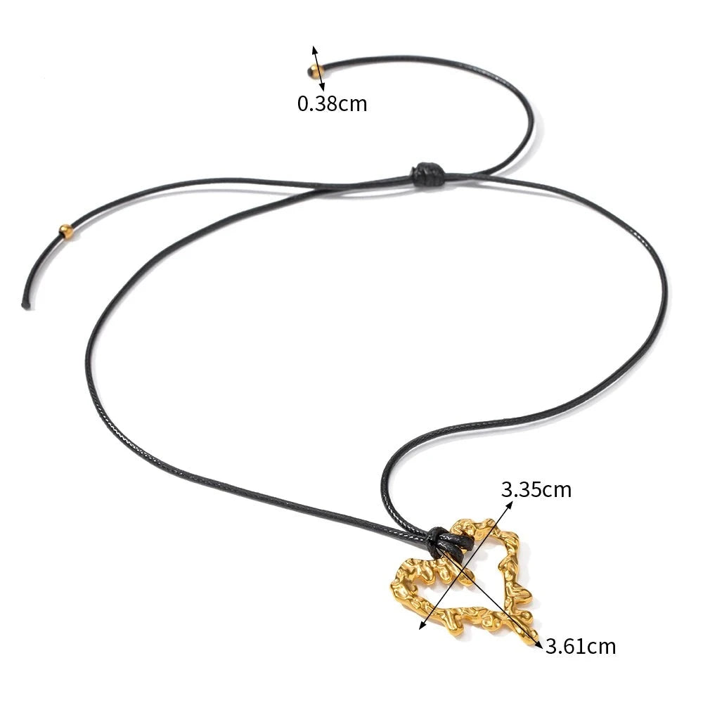 This glam rock necklace is made of gold plated stainless steel pendant which is hanging on a black wax rope. The hollow heart pendant comes in two colours: gold and silver. Its shape imitates lava, which gives the necklace an interesting look. It is a perfect piece for any daily occasion. 