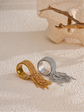 Load image into Gallery viewer, Make a bold statement with this stainless steel chain tassel finger ring, featuring an eye-catching adjustable design in both gold and silver 18K plated finishes. Crafted from high-quality stainless steel, this stylish ring combines elegance with modern charm. The delicate chain tassel detail adds a unique touch, making it a perfect accessory for any fashion-forward jewelry lover. Ideal for both casual and special occasions!
