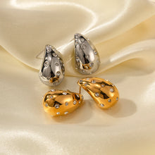 Load image into Gallery viewer, These chic chubby waterdrop stud earrings bring a touch of elegance with their sleek gold and silver color options and embedded zircon accents that add a hint of sparkle. Crafted from durable stainless steel, they’re designed to be both stylish and long-lasting, making them a versatile accessory for any occasion.
