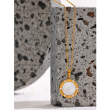 Load image into Gallery viewer, Stainless steel delicate necklace comes in a gold colour. It is made of fine and thin link chain and it has beautiful round pendant . Pendant is made of natural shell and it is circled with a fine golden border. It is also additionally adorned with small zircons which gives the necklace chic and stylish look. This necklace can be worn with any daily outfit. It has lobster clasp and adjustable length.
