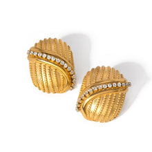Load image into Gallery viewer, Add a touch of elegance and sparkle to your style with these 18K gold plated stainless steel cross line inlaid rhinestone stud earrings. Featuring a sleek cross-line design adorned with shimmering rhinestones, these earrings are perfect for adding a sophisticated finish to any look. Crafted from durable stainless steel with a radiant gold plating, they offer long-lasting shine and tarnish resistance. 
