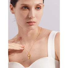 Load image into Gallery viewer, This fashion 18K gold plated stainless steel necklace comes in a gold colour. It is adorned with an interestingly shaped pendant on which we have two smaller pendants hanging: one natural freshwater pearl and one squared cubic zirconia. This simple but trendy necklace is perfect accessory for any outfit due to its minimalistic design. It has lobster clasp and adjustable length.
