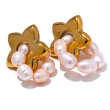 Load image into Gallery viewer, These luxurious drop earrings showcase lustrous natural freshwater pearls paired with delicate stainless steel stars, creating a captivating blend of elegance and whimsy. Crafted with high-quality materials, these earrings offer durability and shine, making them an ideal accessory for fashion-forward individuals who love premium jewelry.
