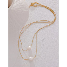 Load image into Gallery viewer, This glamorous stainless steel necklace features an elegant double chain design, each strand adorned with a single, lustrous natural freshwater pearl. The larger pearls add a touch of sophistication and elevate the necklace&#39;s overall style, making it a striking accessory. Perfect for complementing an evening outfit or adding a touch of elegance to your daily look, this versatile piece is both stylish and refined. The necklace is finished with a secure lobster clasp and an adjustable chain.
