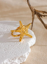 Load image into Gallery viewer, Embrace the essence of summer with this stainless steel starfish open ring, a playful and elegant accessory perfect for your holiday look. 18K gold plated for a luxurious finish, this adjustable ring features a charming starfish design that brings a touch of the ocean to your style. Crafted for durability and comfort, it’s an ideal piece for those who love personalized, summer-inspired jewelry.
