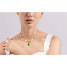 Load image into Gallery viewer, This romantic and luxurious necklace is made of natural freshwater pearls and stainless steel components. The necklace is adorned with a nice green stone circled with golden border and cubic zirconia.  There is a toggle clasp above the stone which is also adorned with cubic zirconia. Necklace is perfect accessory for any evening outfit. 
