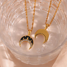 Load image into Gallery viewer, This very elegant pendant necklace is made out of 18K gold plated stainless steel. Pendant is in a shape of a moon and it comes in two colours: black or white. The moon is additionally adorned with a line of cubic zirconia. Necklace can be combined with an elegant dinning outfit and it can be a perfect gift for a special one. It has a size adjustable lobster clasp.&nbsp;
