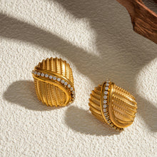 Load image into Gallery viewer, Add a touch of elegance and sparkle to your style with these 18K gold plated stainless steel cross line inlaid rhinestone stud earrings. Featuring a sleek cross-line design adorned with shimmering rhinestones, these earrings are perfect for adding a sophisticated finish to any look. Crafted from durable stainless steel with a radiant gold plating, they offer long-lasting shine and tarnish resistance. 
