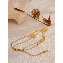 Load image into Gallery viewer, Add a touch of summer romance to your style with this exquisitely crafted gold anklet. Made from high-quality, gold-plated stainless steel, it features a delicate double-chain design. One chain is adorned with dainty gold beads, while the other is beautifully decorated with charming white flowers, creating a perfect balance of elegance and whimsy. With its secure lobster clasp and adjustable length, this anklet is the ideal accessory to enhance your summer look, adding a subtle yet sophisticated touch to yo
