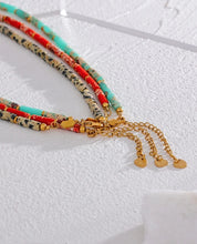 Load image into Gallery viewer, Necklace is made out of big red natural stone beads in a shape of a cilindar. There are small beads in between the red ones made of stainless steel in gold colour. This necklace is a perfect piece for summer elegant outfit. The necklace has a size adjustable chain with a lobster clasp.&nbsp;
