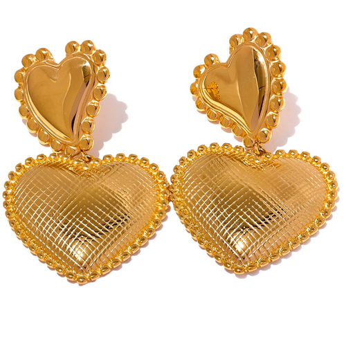 These romantic drop earrings feature an enchanting design with a larger heart gracefully dangling from a smaller one, each crafted from hypoallergenic stainless steel and plated in radiant 18K gold or classic silver. The textured surface and intricate edges add depth and charm, creating an eye-catching look that's both elegant and playful. 