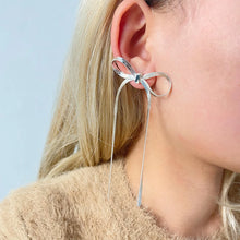 Load image into Gallery viewer, These long tassel bow earrings are a striking statement piece, featuring a graceful bowknot design with sleek flat snake chains that add a sense of fluid movement. Made from high-quality stainless steel, they are both durable and lightweight, offering a stylishly modern look with a hint of elegance. 
