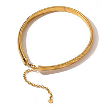 Load image into Gallery viewer, This luxurious statement necklace is made of stainless steel and is real gold plated. It comes in two colours: gold and silver. Its simple design and snake chain pattern makes this necklace a great accessory for any daily or evening outfit and gives it a glamorous touch. The necklace has a lobster clasp and adjustable length. 
